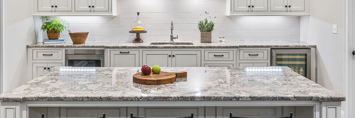 beige colored kitchen with granite countertops and white cabinets