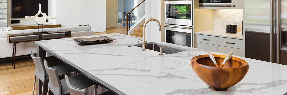 neutral colored codern kitchen with quartz countertop island and bar stools